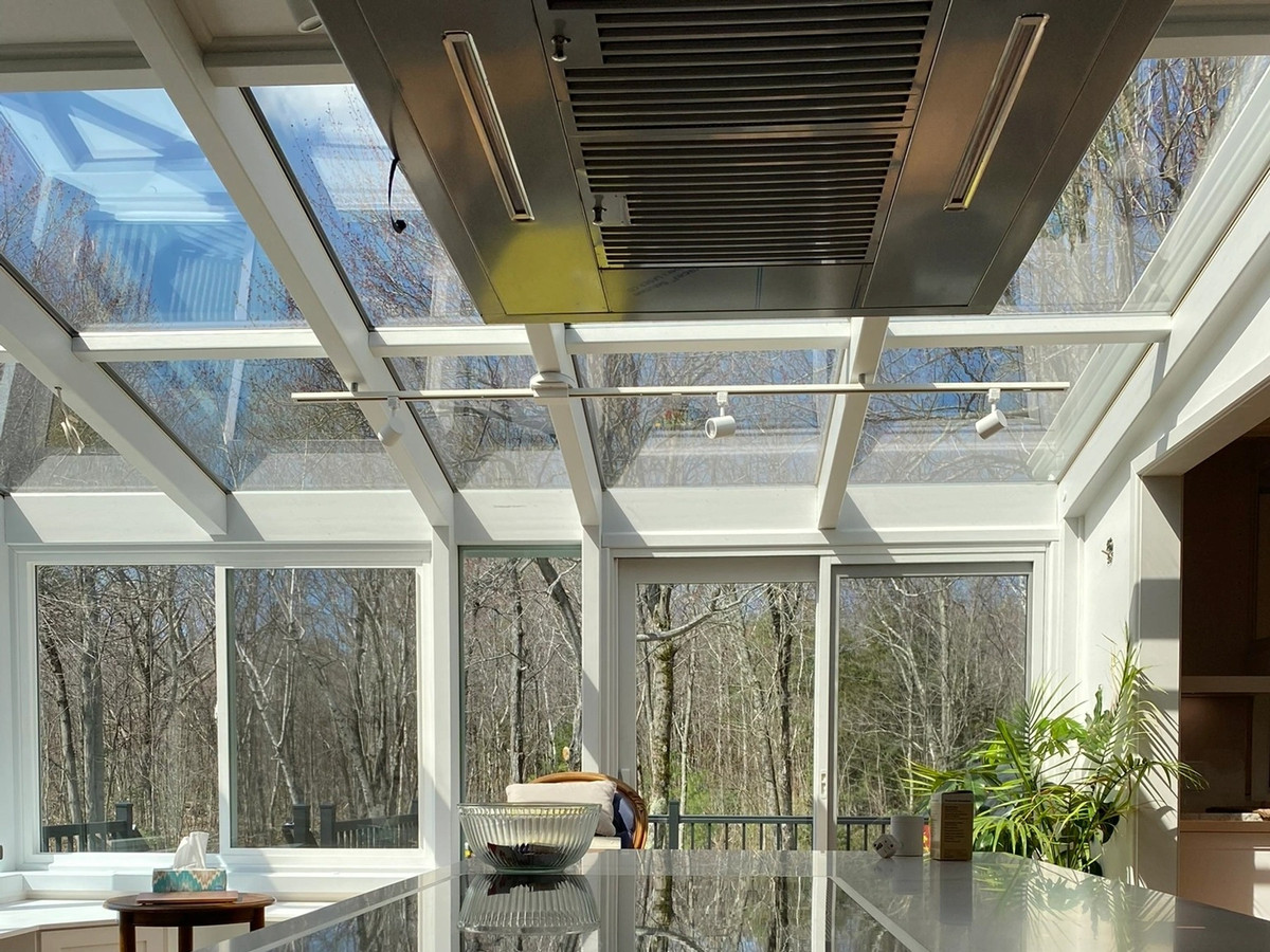 Track lighting installed across a glass sunroom ceiling by Chair City Electric