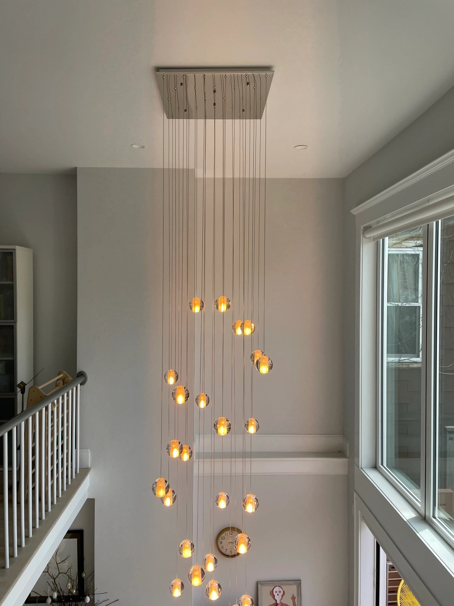 Cascading pendant chandelier installed by Chair City Electric in a two-story stairwell